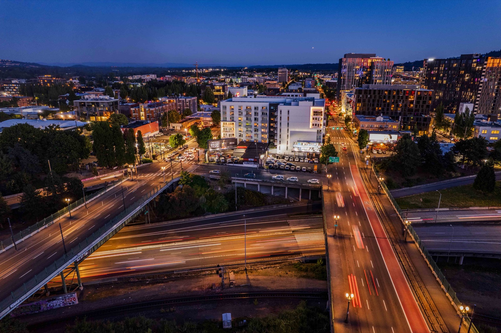 Aerial night cityscape with freeway light trails